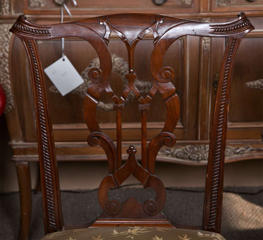  Set of eight dining room chairs by the Charak Furniture Company. Very fine solid mahogany ribbon back chippendale chairs having carved legs and carved back supports. The set compromising a set of six side and pair of arm chairs.