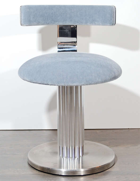 This very sophisticated vanity stool features a ribbed pedestal base in polished chrome with a brushed chrome base and newly upholstered in a pewter mohair.It swivels as well.