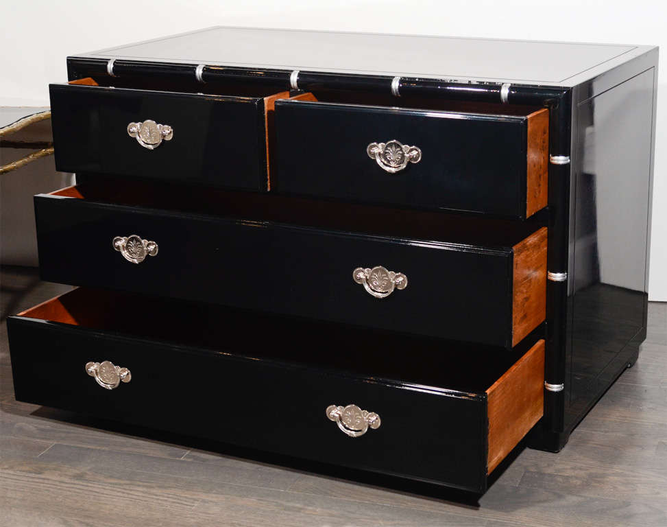 Art Deco Low Chest in Black Lacquer features Silver Leaf Detailing and Asian Inspired Nickeled Pulls, four spacious drawers and a vitrolite top. This piece encapsulates the American Chinoiserie Art Deco aesthetic at its most refined.

American,