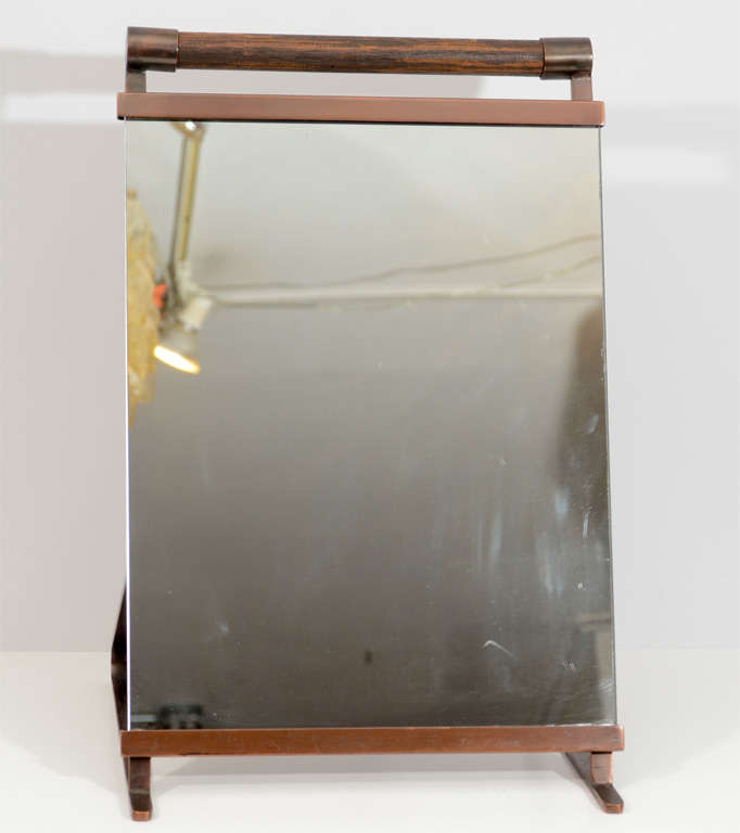 Handsome copper and oak tabletop dressing mirror. This is a versatile piece and can be used on the floor to look at your shoes as well. Very nicely detailed with an attractive patina. Please contact for location.