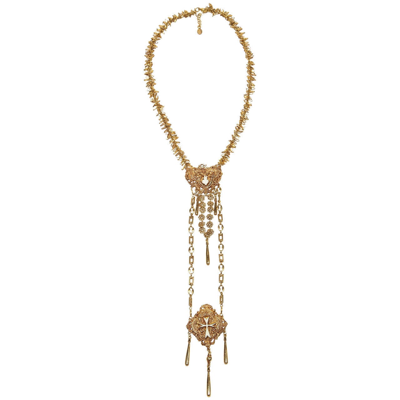 A striking double drop necklace by Christian Lacroix of gilt metal, enamel details in each pendant and rhinestone accents, including the CL at the top of the first pendant. Nicely detailed with various types of chain, including a fringed chain at