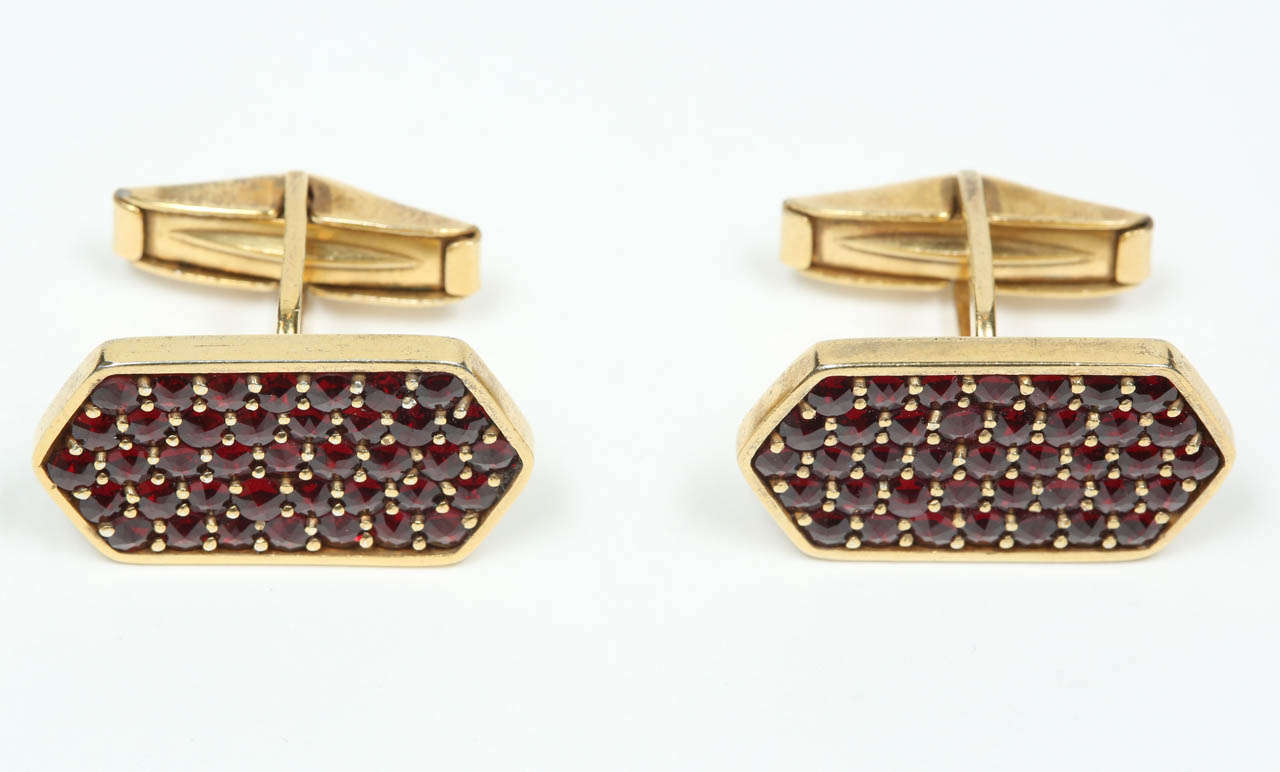 An elegant pair of gold washed sterling silver and pavé set garnet cufflinks. Stamped with the Paris sterling hare head guarantee, as well as 