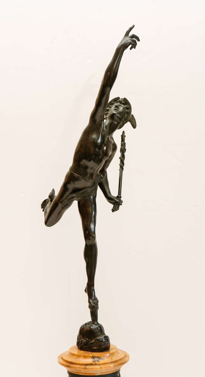 Bronze sculpture of ascending, winged mercury bearing a caduceus in the manner of Jean de Boulogne (1529-1608). The whole is mounted on a marble base surrounded by a bronze relief.