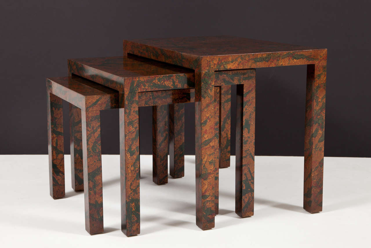 Parsons-style nesting tables with a remarkable lacquer finish of deep green and burgundy spots over a gold dust background, American, circa 1960.
