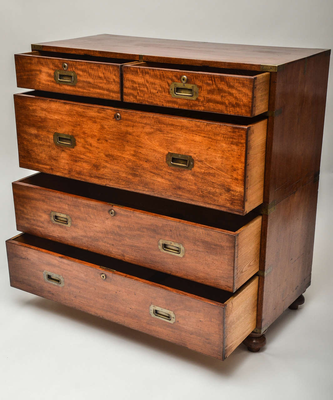 A 19th century mahogany Campaign chest, two part, original brass binding, brass locks and handles, turned feet.