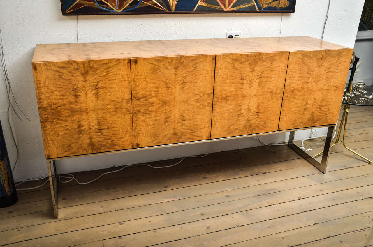 Outstanding burl wood, chrome base credenza with interior drawers and shelving by Milo Baughman.