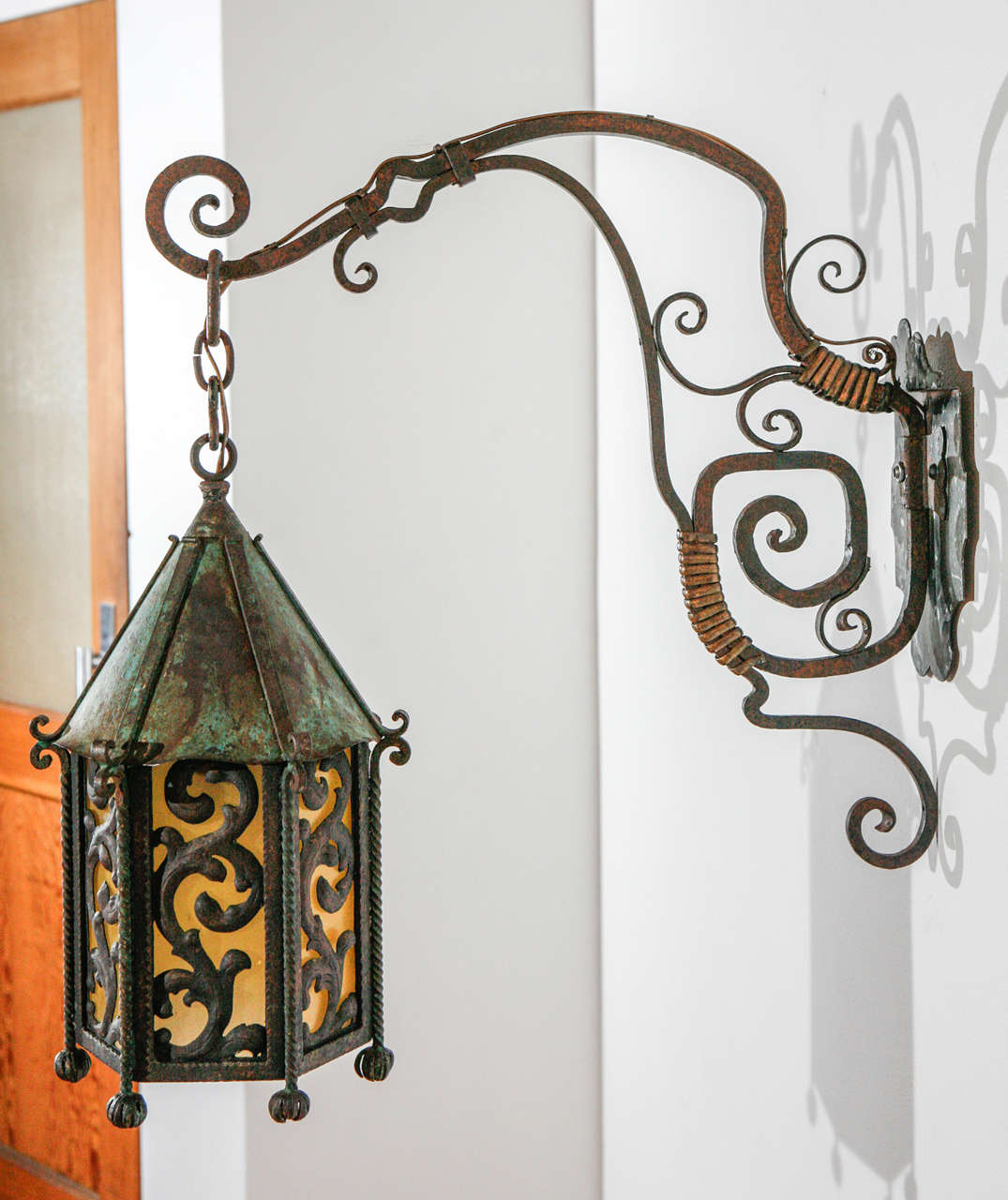 Massive exterior iron sconce with beautiful brass detailing.