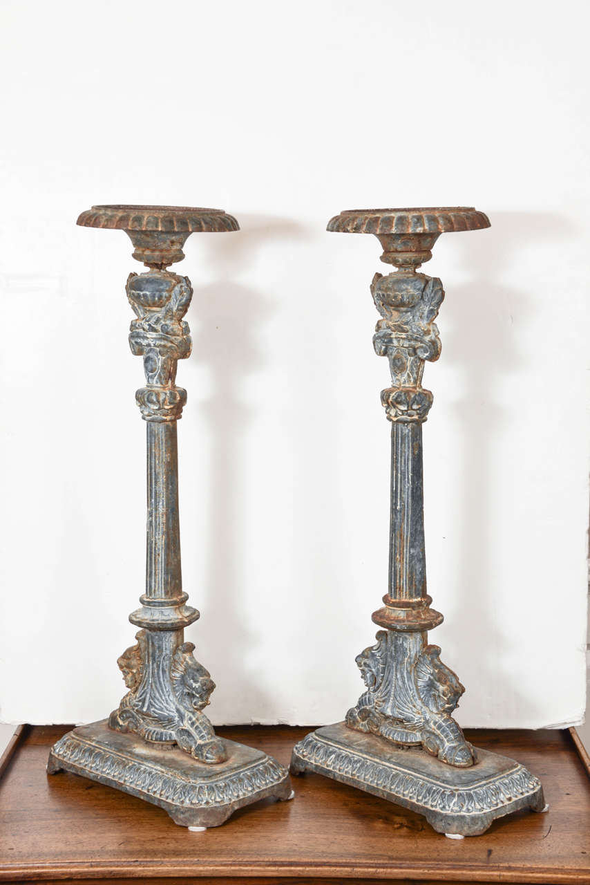 Grand and highly detailed cast iron candlesticks will hold up to a 5.75