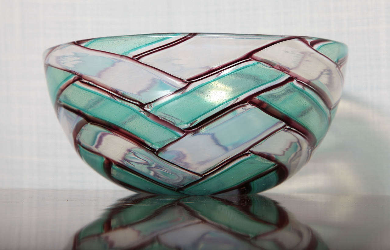 Studio made glass bowl with shades of blue, green and brown, creating a pattern resembling interwoven lines. This bowl was produced by Barovier & Toso, Murano, Italy. Etched signature on underside.
