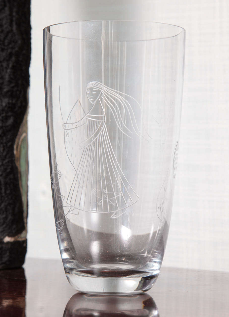 Clear glass vase with etched images of a woman, birds and other nature related symbols. A beautiful example of 1950s Finnish glass. Etched signature on underside.