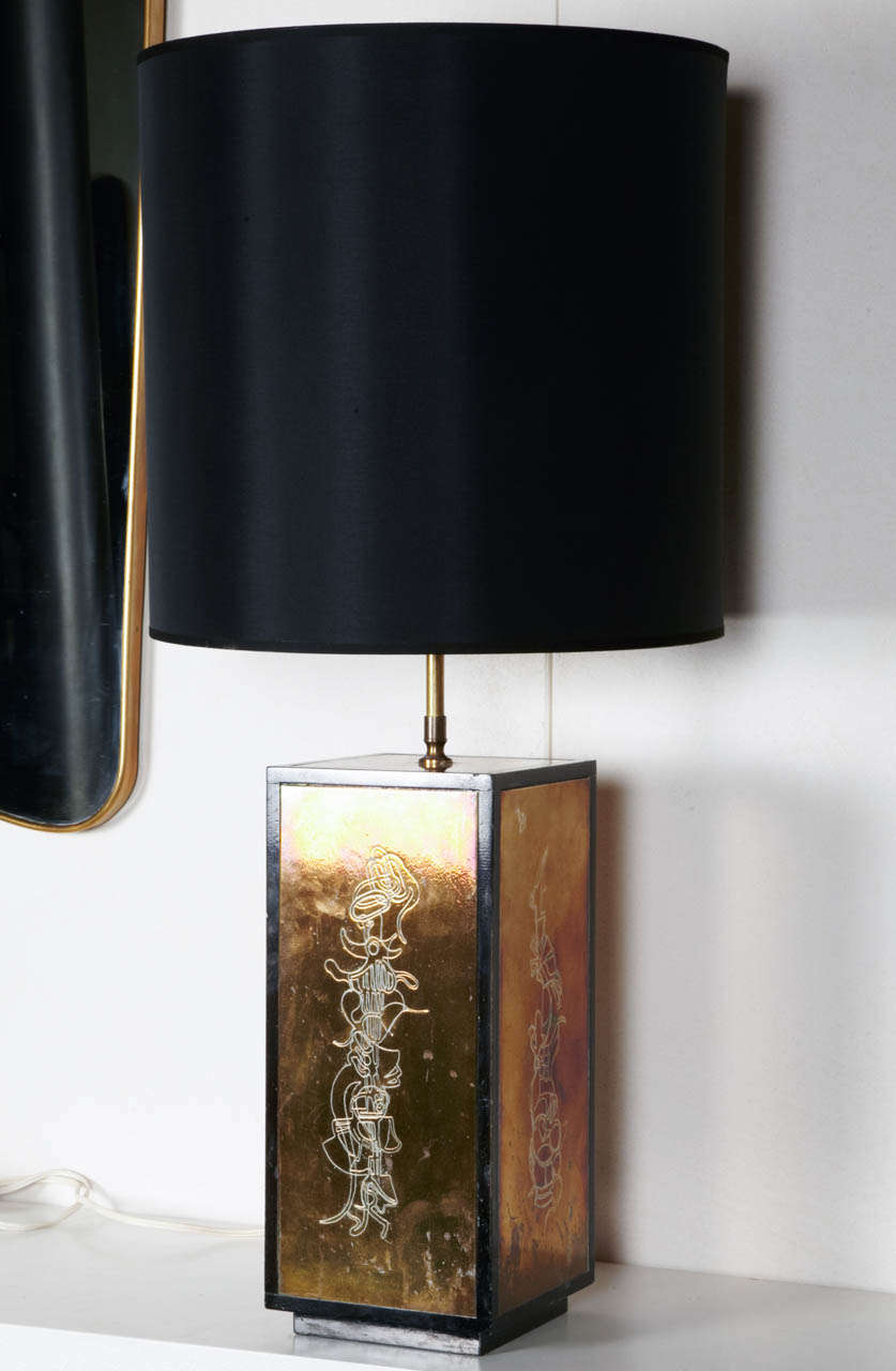 Engraved Brass and wood table lamp by Catherine ROISIN, France, circa 1980.
Black shade.
Dimensions (without shade) : H. 87 x W.17 x D.17 cm`
Shade : H. 39 x diam. 40 cm
Total : H. 88 x diam. 40 cm
Fair condition.