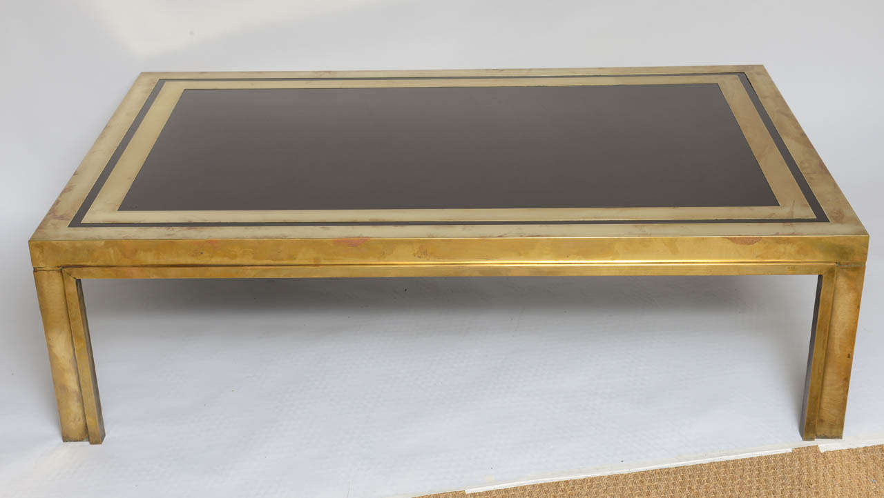 High gloss laminated top in dark brown/maroon and brass shows natural original patina.
 