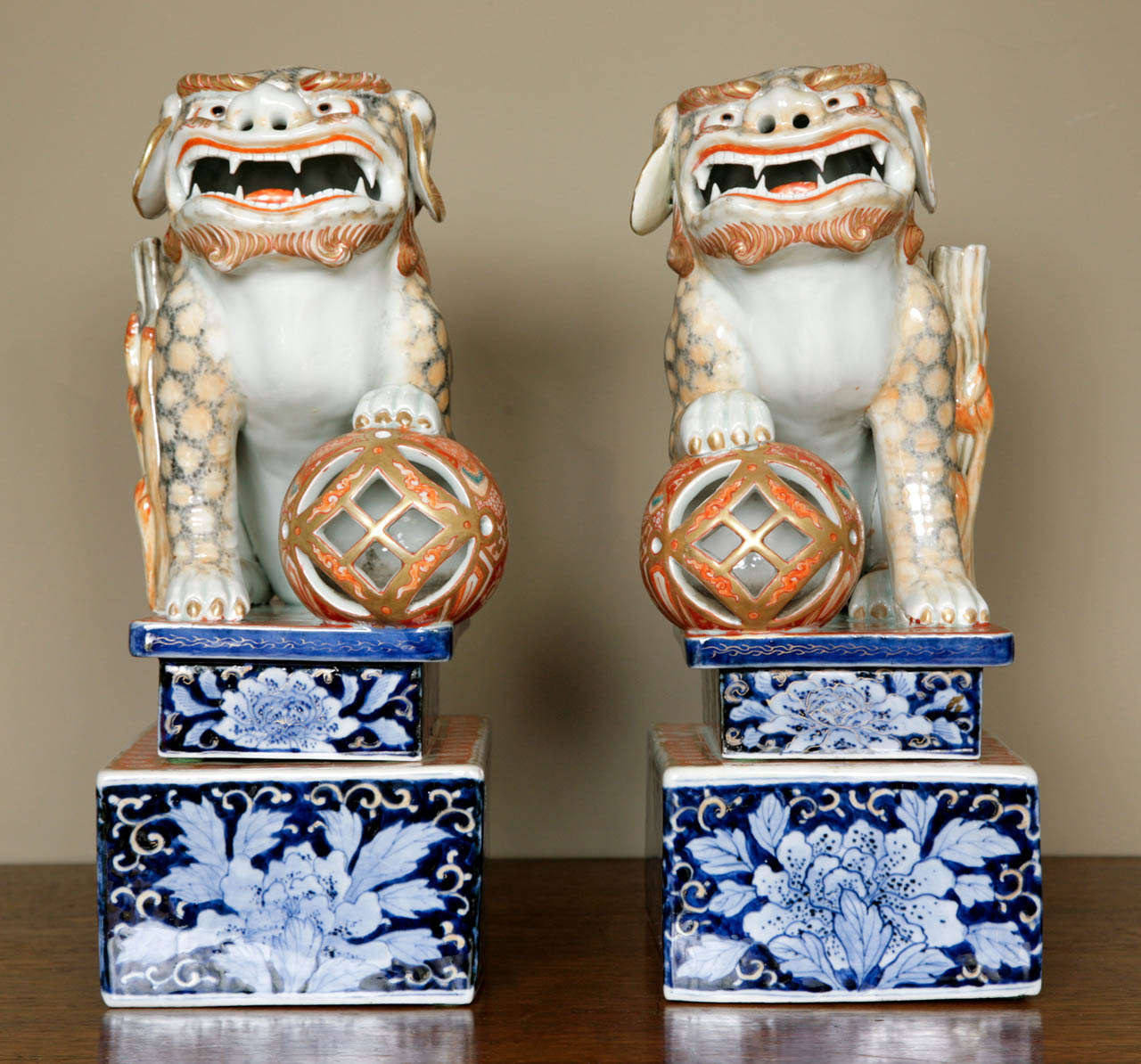 A Large pair of Japanese Porcelain Foh dogs on Plinths, Meiji