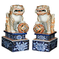 A Large pair of Japanese Porcelain Foh dogs on Plinths, Meiji