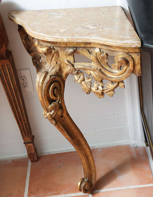 Pair of gilded carved wood corner console tables with original marble tops