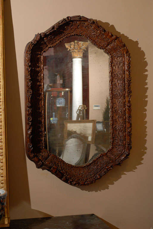 This beautiful Black Forest mirror signed, (carved signed) G Eurelpe, from the parish of Brienz is early-mid-19th century. This particular mirror is heavily carved detailed Leafy with Alpine roses. Beautiful clean carvings depicting horticulture in