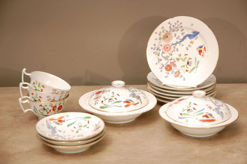 An English soft paste porcelain breakfast set, decorated in the Japanese Kakiemon Style.  Set consists of 5 cups and saucers, 6 plates (7 1/2