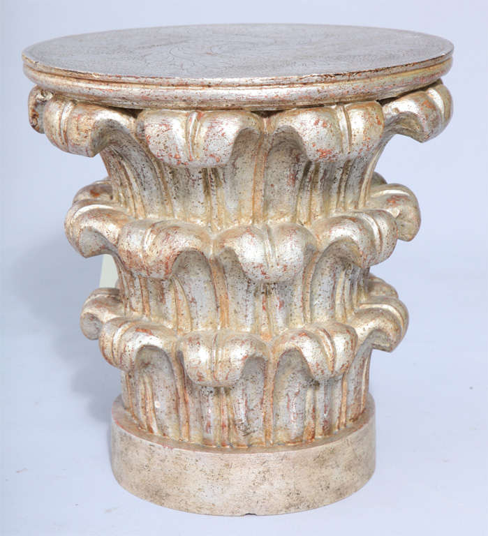 Carved silver giltwood table in form of a Corinthian capital, its round top delicately carved with leafy design.<br />
<br />
(Keywords: Accent table, cigarette table, side talbe)