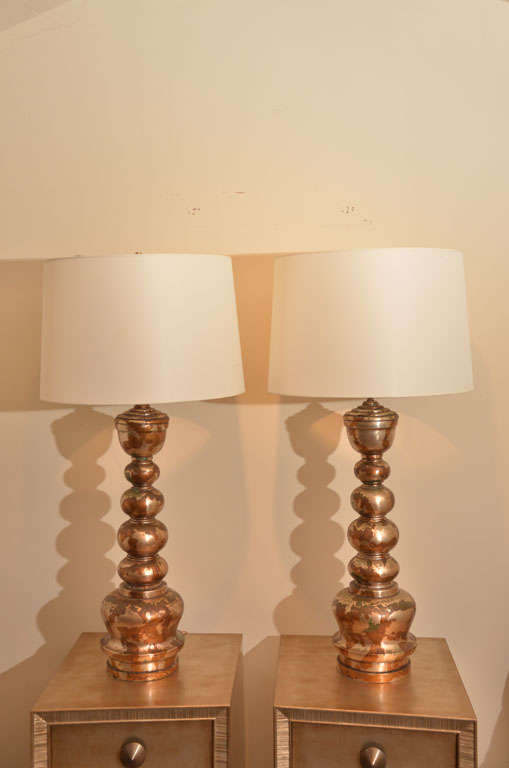 This large pair of stacked ball lamps have been beautifully leafed in one of<br />
 JAMES MONT'S signature camouflage leaf  finishes. The lamps have been newly rewired and are accompanied by new fabric shades.