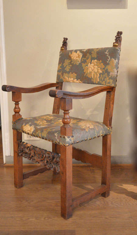 A set of four armchairs, each with a different musical subject on the back.
