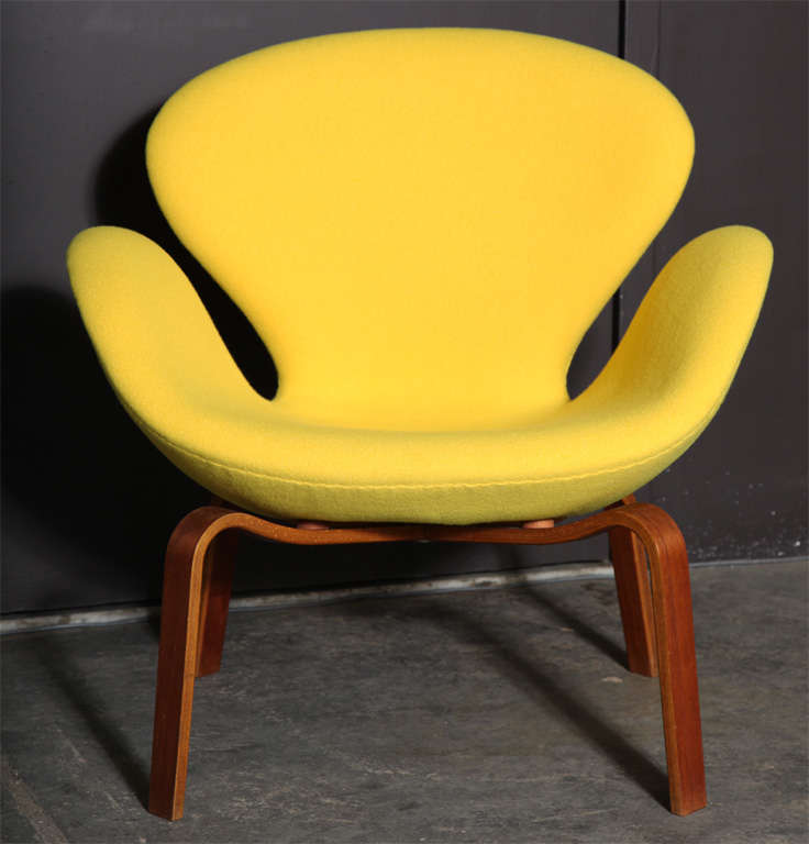 Vintage 1950s Arne Jacobsen swan chair with wooden legs.

Original and rare swan chair by Arne Jacobsen for Fritz Hansen. Features teak legs, new foam and new sunny yellow wool upholstery. Ready for pick up, delivery, or shipping.