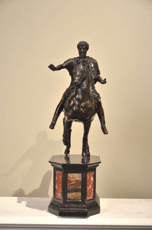 Marcus Aurelio. A bronze sculpture with dark patina, by the original model of the sculpture of the Imperial Roman Period. The base is in Nero del Belgio marble quality with diaspers.