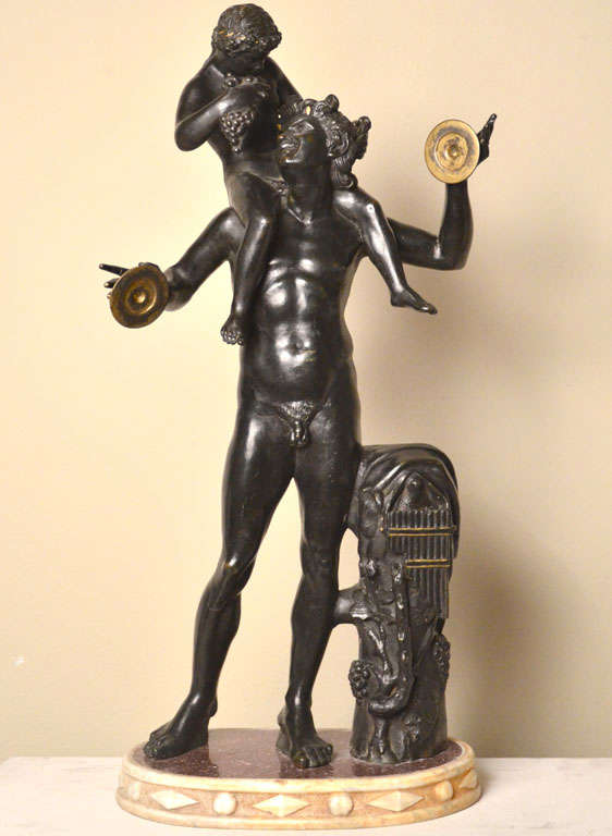 Satyr And Dionysus. A bronze sculpture with dark patina. Antique and very rare porphyry and white marble base. The sculpture is by the original roman model today at the Farnese Collection.