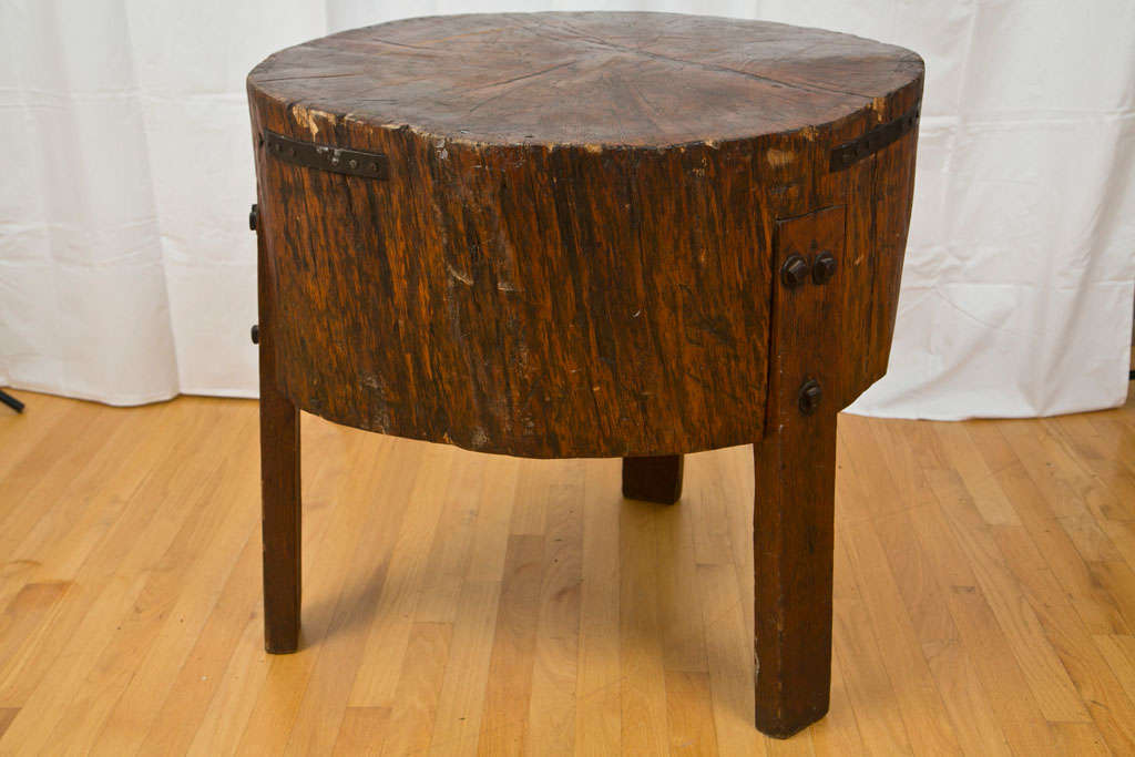 Extremely heavy and well-worn butcher block table from the early 18th century. Made of old-growth timber, the legs were added at a later date. Uneven top surface. A great rustic addition to any kitchen.