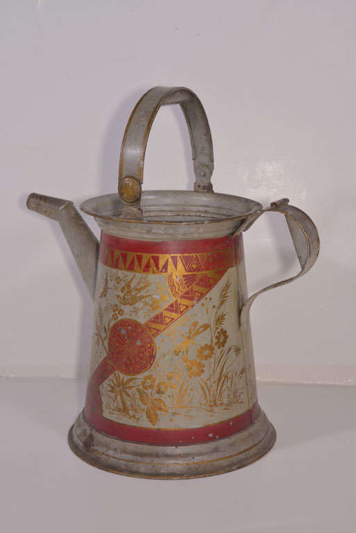 Zinc watering can with original gilt and red paint.