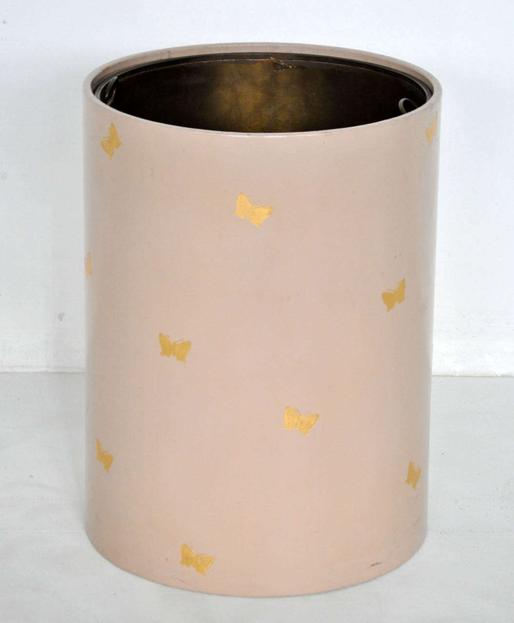 Large wastebasket clad in leather with gold embossed butterflies.  Brass pull-out liner.