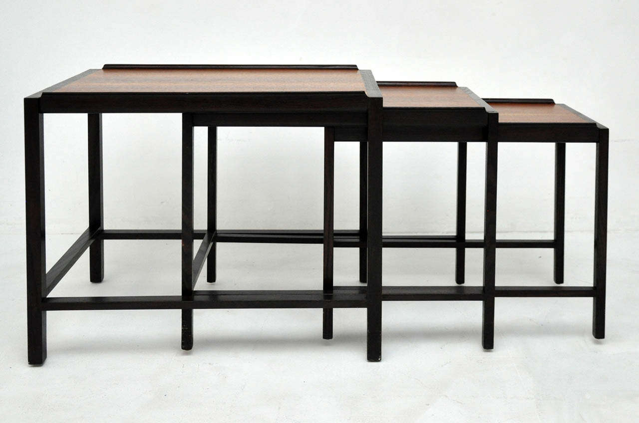 Set of three nesting tables by Edward Wormley for Dunbar. Dark finish frames with walnut tops.