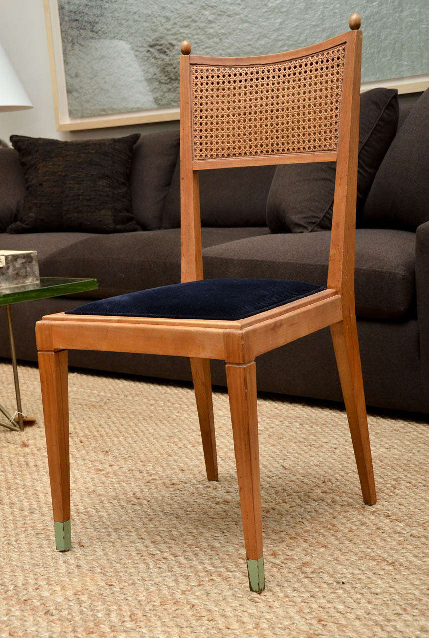 Unique set of four dining chairs were commissioned by the secretary of a french government official in the 1950s. The painted sabot sets them apart. Newly upholstered in a navy corduroy.