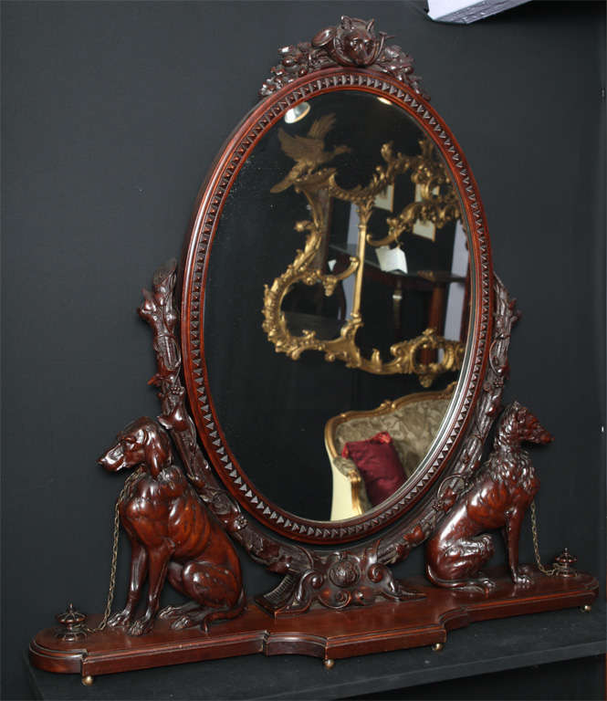 A magnificently carved cheval / vanity mirror