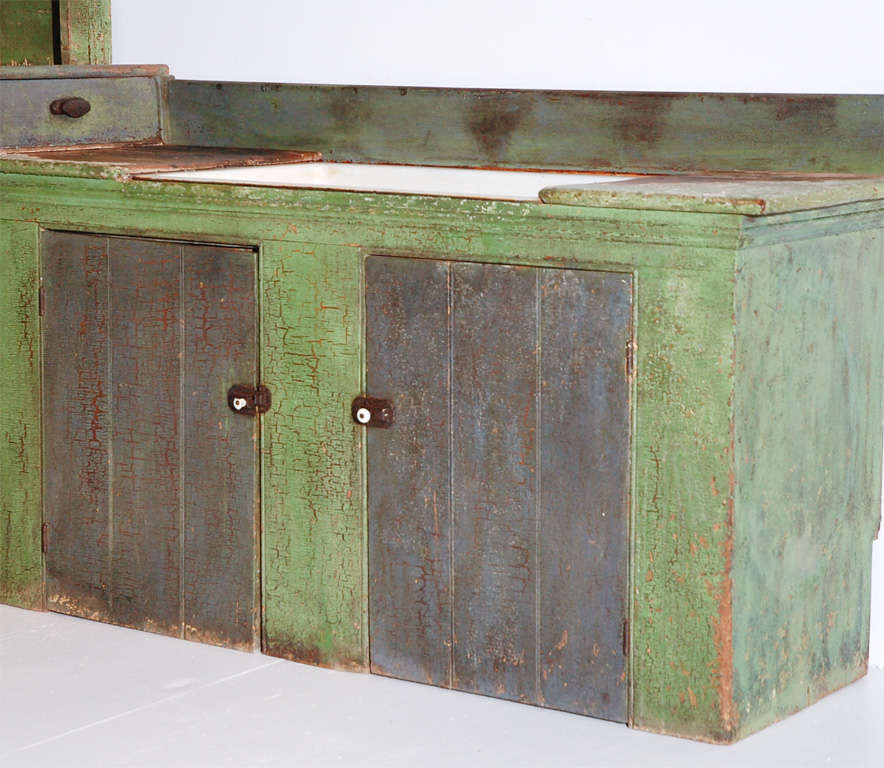 19THC VERY UNUSUAL THREE PIECE STEP BACK CUPBOARD WITH A COMBINED SINK CABINET FROM PENNSYLVANIA.THIS FANTASTIC STEPBACK CUPBOARD HAS A WONDERFUL ALIGATORED SURFACE AND A WONDERFUL BUTTERMILK CREAM PAINTED INTERIOR WITH MULTIBLE SHELVING