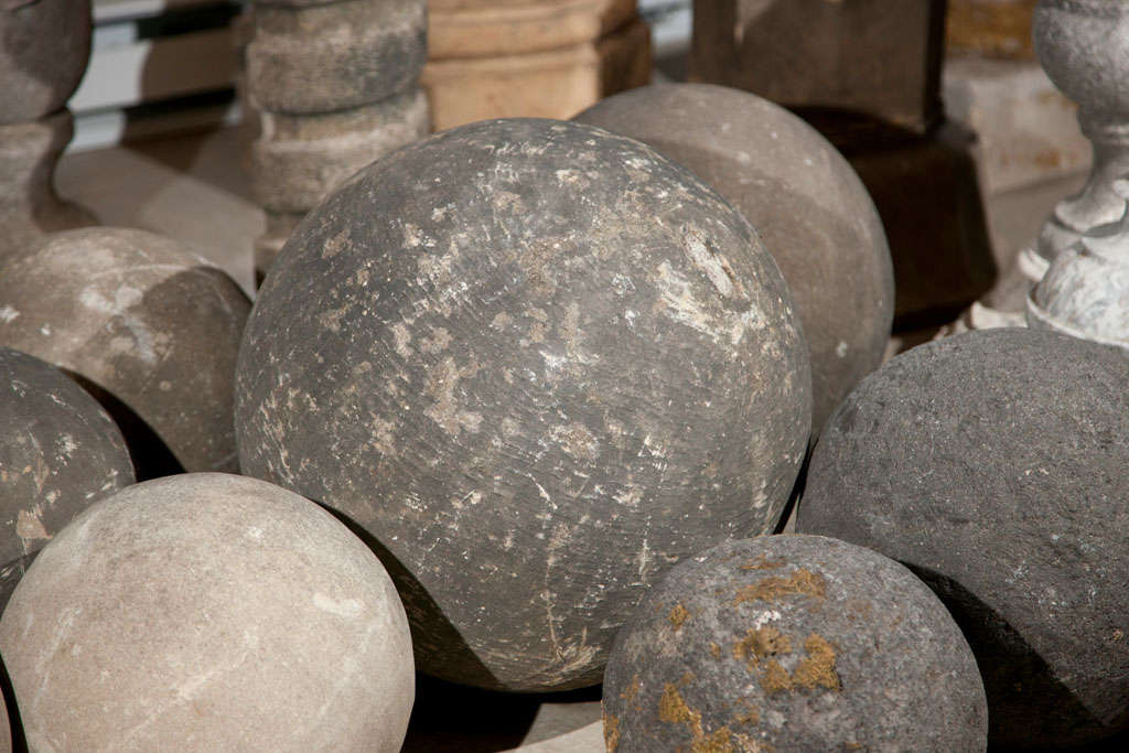 An assortment of carved stone balls, from England, France, Italy - 17th, 18th, and 19th century each with its own unique style. Some singles, some pairs, some light, some dark, in sizes ranging from 9