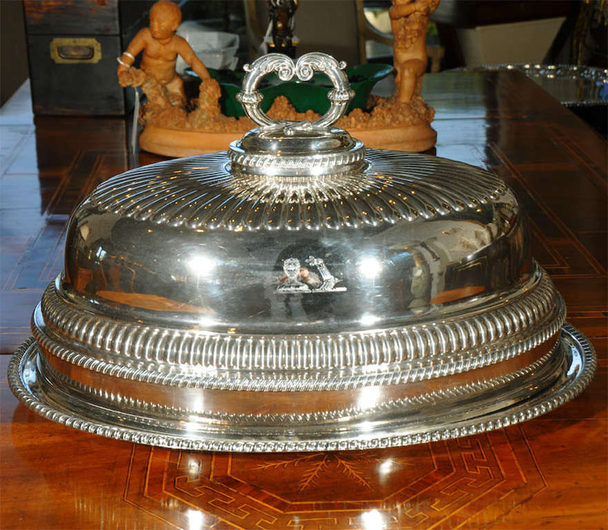 a silver plated roast platter with dome cover having beautiful gadrooned edges<br />
<br />
crest with a bearded warrior / man whose upturned left arm clad in armor grasps a fleur de lis (images 2 and 4)