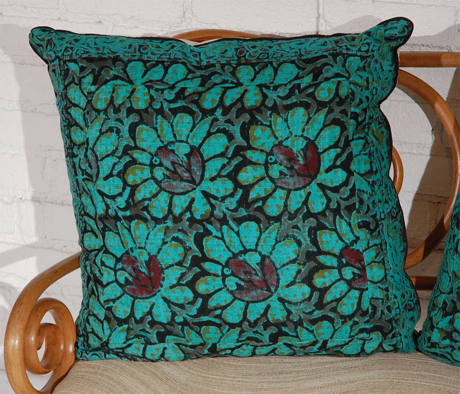 Vintage Indian Batik pillows with a solid natural linen back and a zipper closure.  The pattern is a slightly abstract floral pattern in a deep turquoise and eggplant with touches of black and dark taupe.