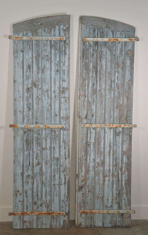 19th c. Wooden shutters with original paint and hardware. Very textured and weathered. Can be used on either side.  4 pair of shutters are available.