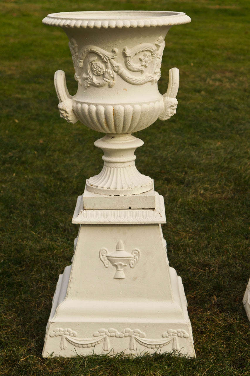 American Pair of Neoclassical Mask and Loop Cast-Iron Urns