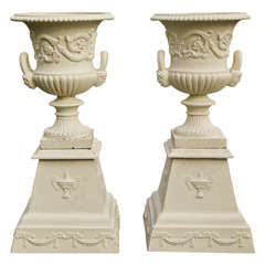 Pair of Neoclassical Mask and Loop Cast-Iron Urns