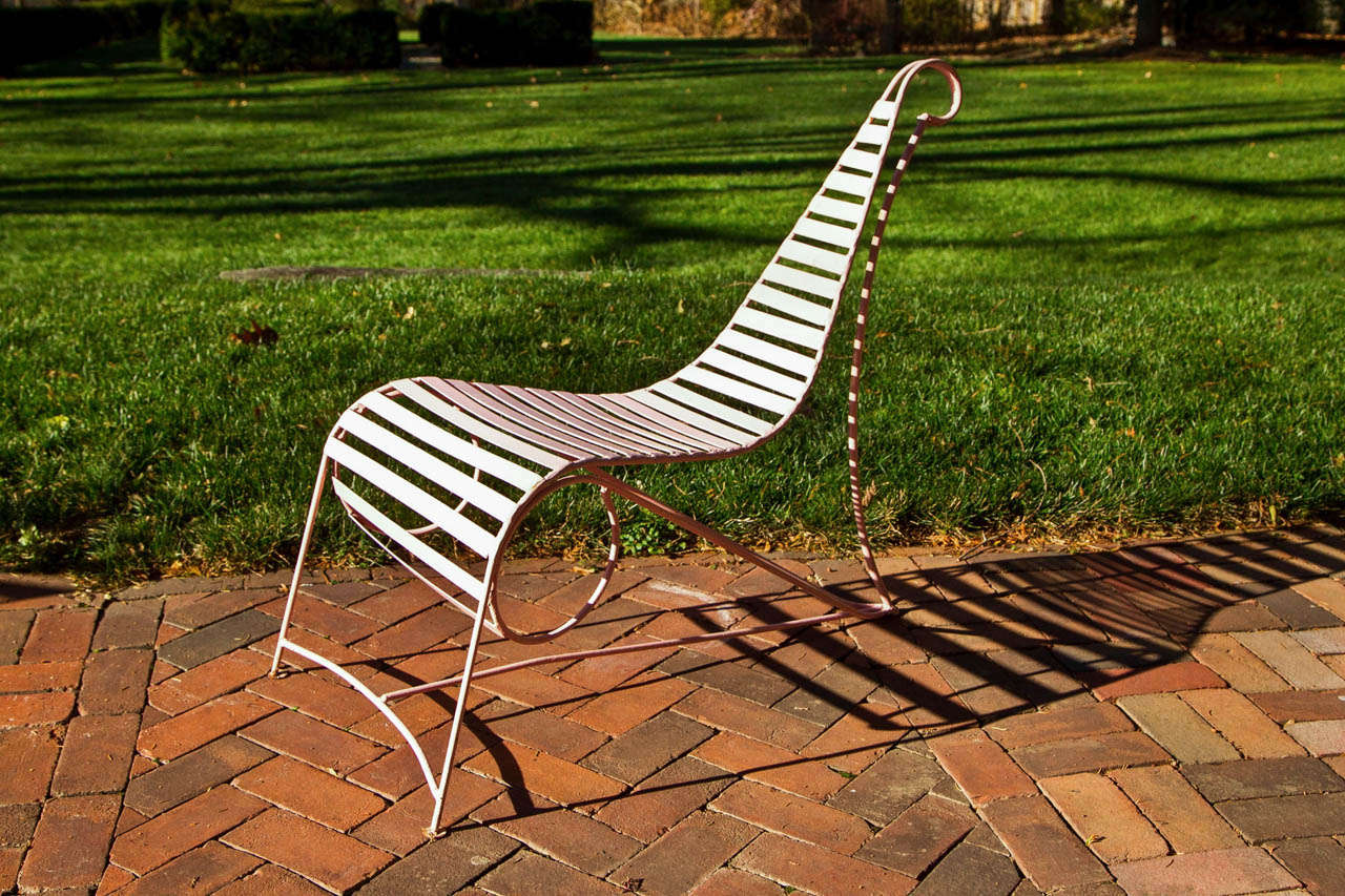 A wrought-iron chair with slats, in the manner of the circa 1986 Spine Chair, designed by Andre Dubreuil (French, born 1951), the sloped back tapered with scrolled terminal.