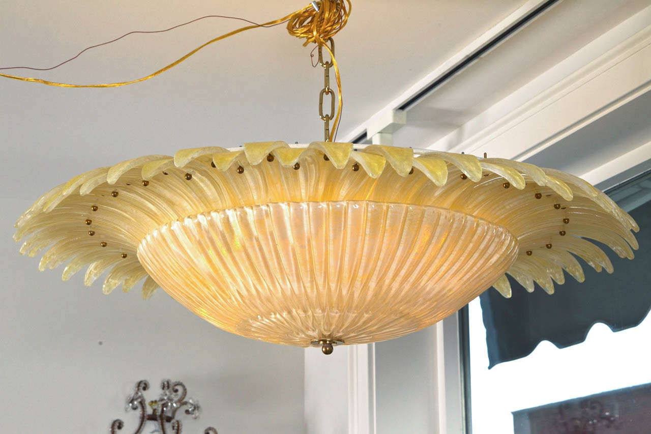 Beautiful parchment  blown Murano ceiling fixture comprised of 60 blown petals. 
This fixtures can be hung as a flush mount or dropped to any height. We can have install ready with a chain or with brass piping. Fixture contains 6 lights of up to 60