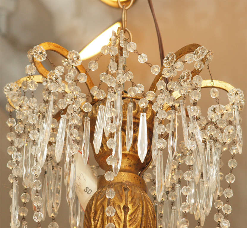 Italian giltwood stem with gilt iron arms and crystal dressing chandelier from the 19th century. Tassel can be replaced with crystal ball.