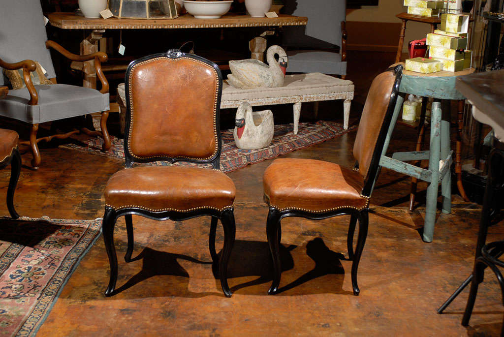 Set of 8 French leather and ebonized chairs.<br />
<br />
To see more items from Foxglove Antiques, please visit our website: www.foxgloveantiques.com