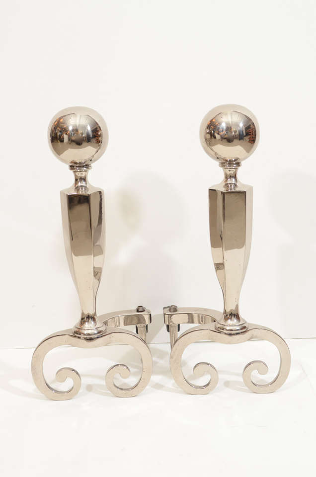 Exceptional stylish pair of Art Deco cannonball andirons with scrolled bases.