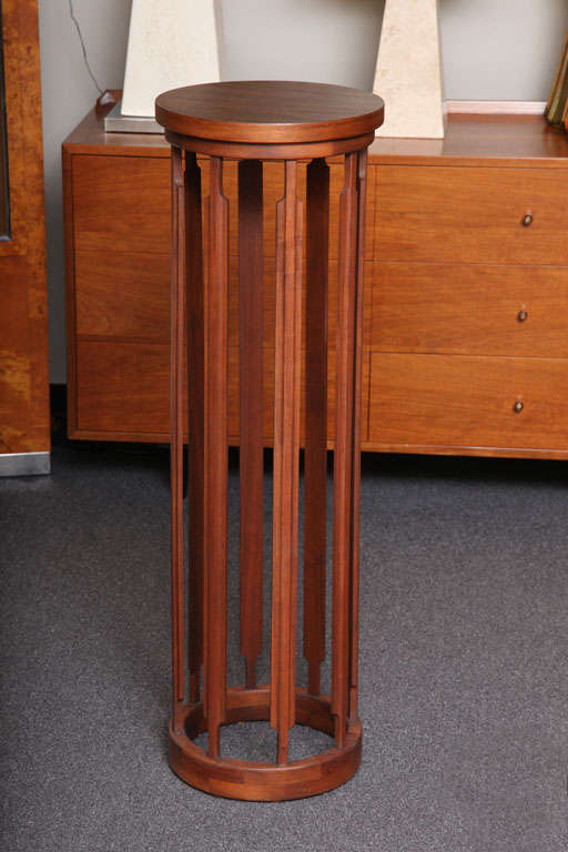 SOLD NOV 2012 Deft wood turning and shaping is evident in this crafted teak pedestal with eight shaped upright supports, rising from an open circular base up to a circular top.  All solid teak with a laminate top.  Unmarked except 5-67 in pencil