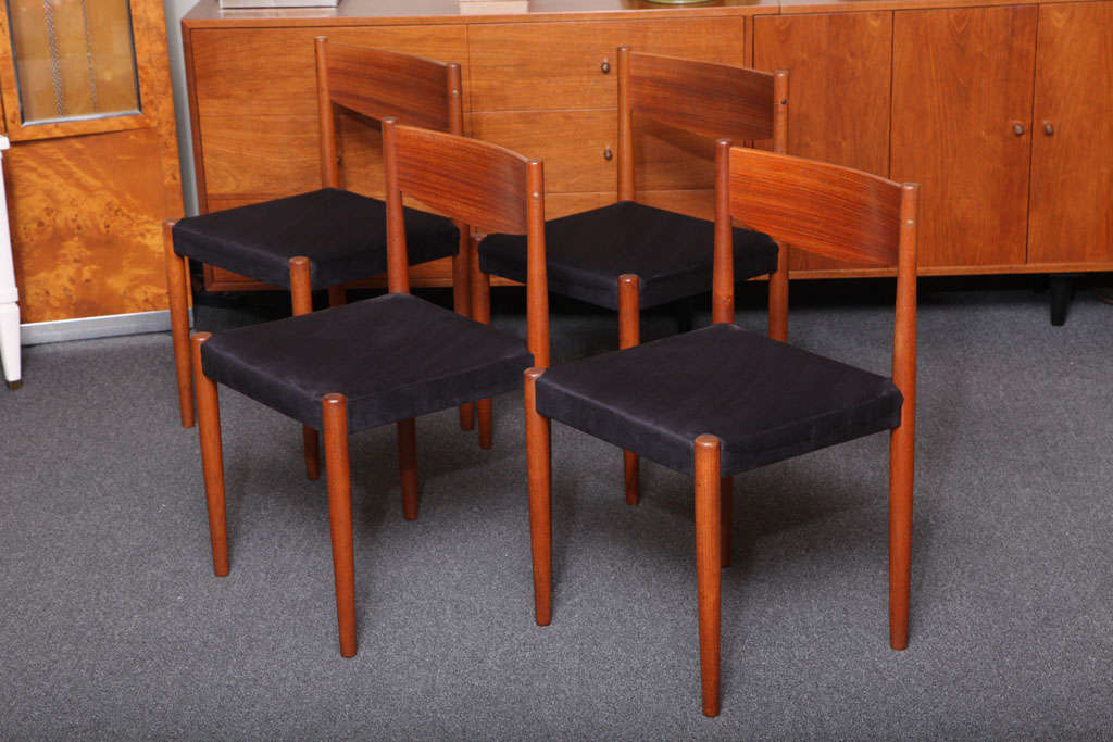 SOLD A set of eight smart teak dining chairs designed by Poul Volther and produced by Frem Rojle in Denmark.  Beautifully crafted with a Shaker simplicity, the richness of the teak readily apparent.  Nicely recover seats in black ultra suede.  Very