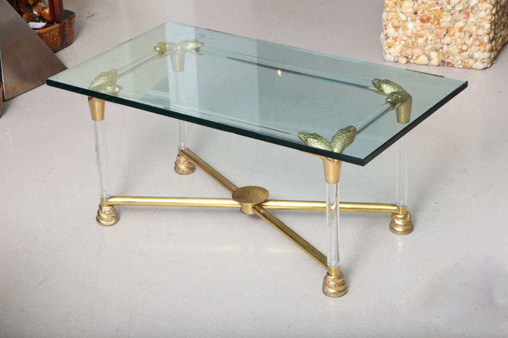 Lucite and brass coffee table with double headed pythons at corner junctions. An unusual table with great attention to detail as python motif repeats at feet in form of coiled body of the snake.