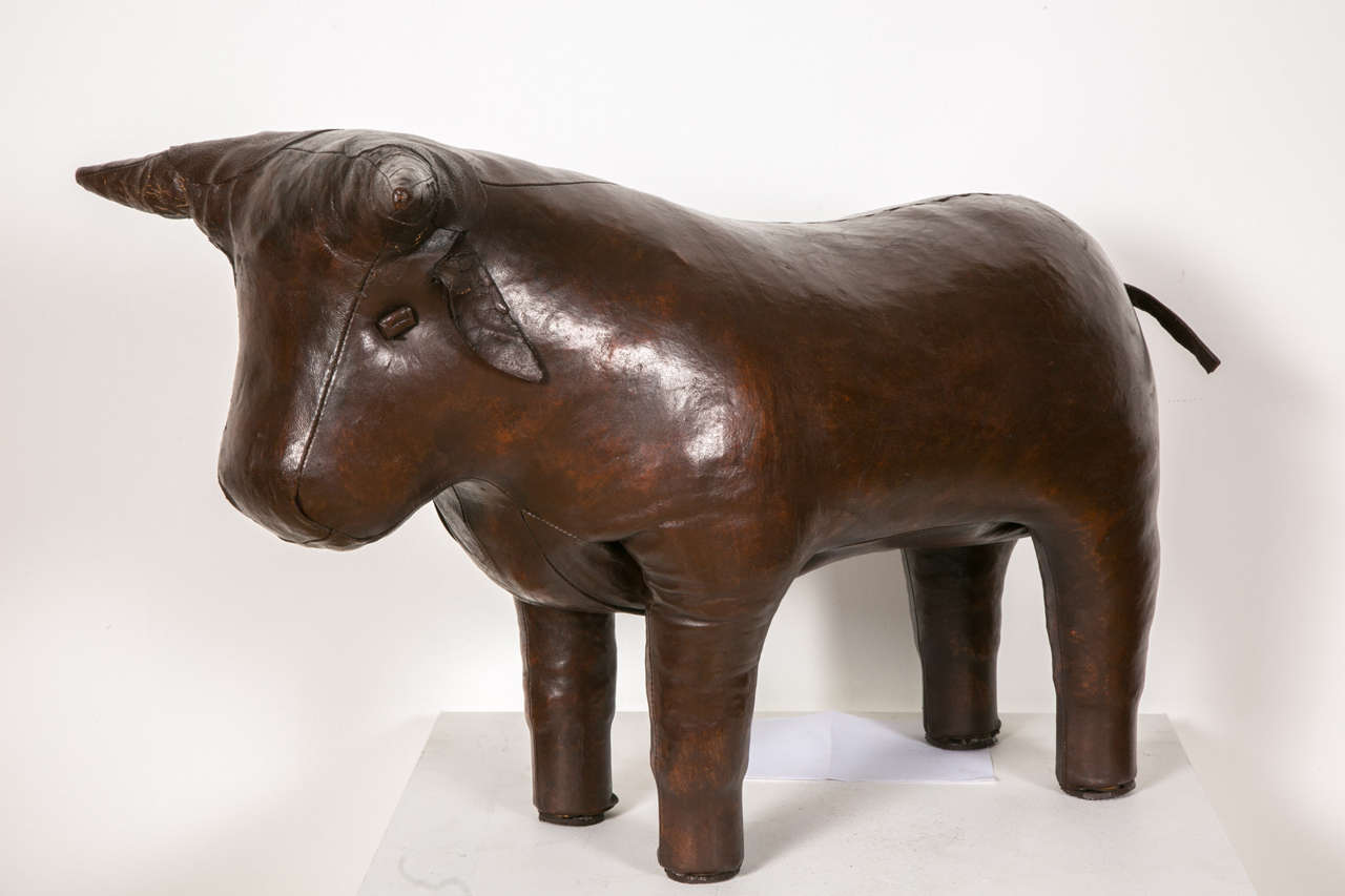 Pouf or ottoman in patinated leather symbolizing a bull by Dimitri Omersa. Ottoman manufactured by Omersa & Co, Lincolnshire England for Liberty's of London. A Dimitri Omersa seat symbolizing a boar is also available.