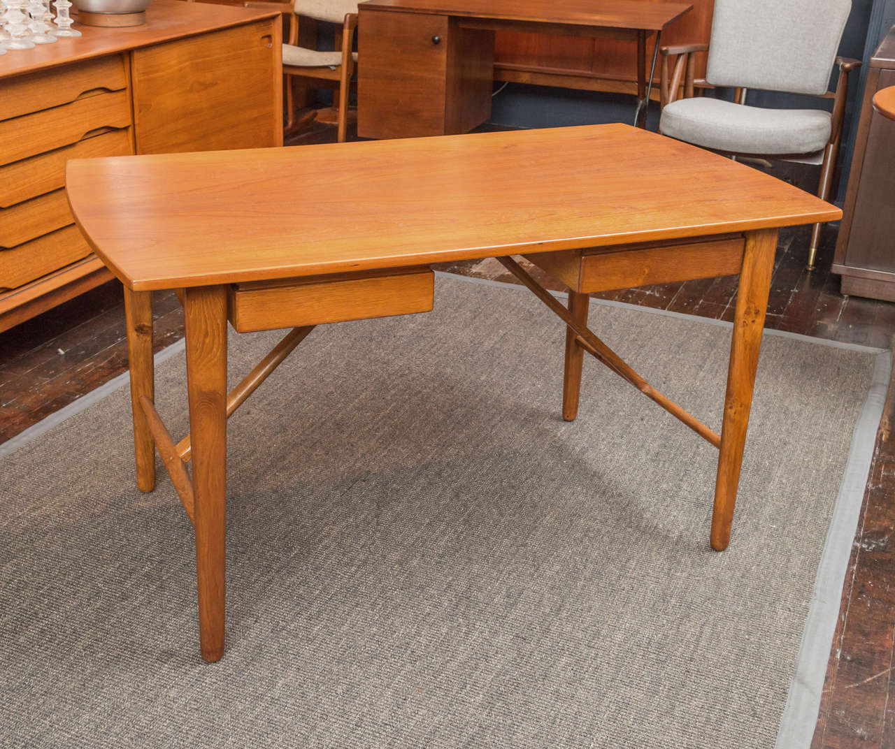Teak table may be used as a table or desk; with extension leaves (removable) and supports; two drawers are visible and accessible from both sides.

H - 28 1/2